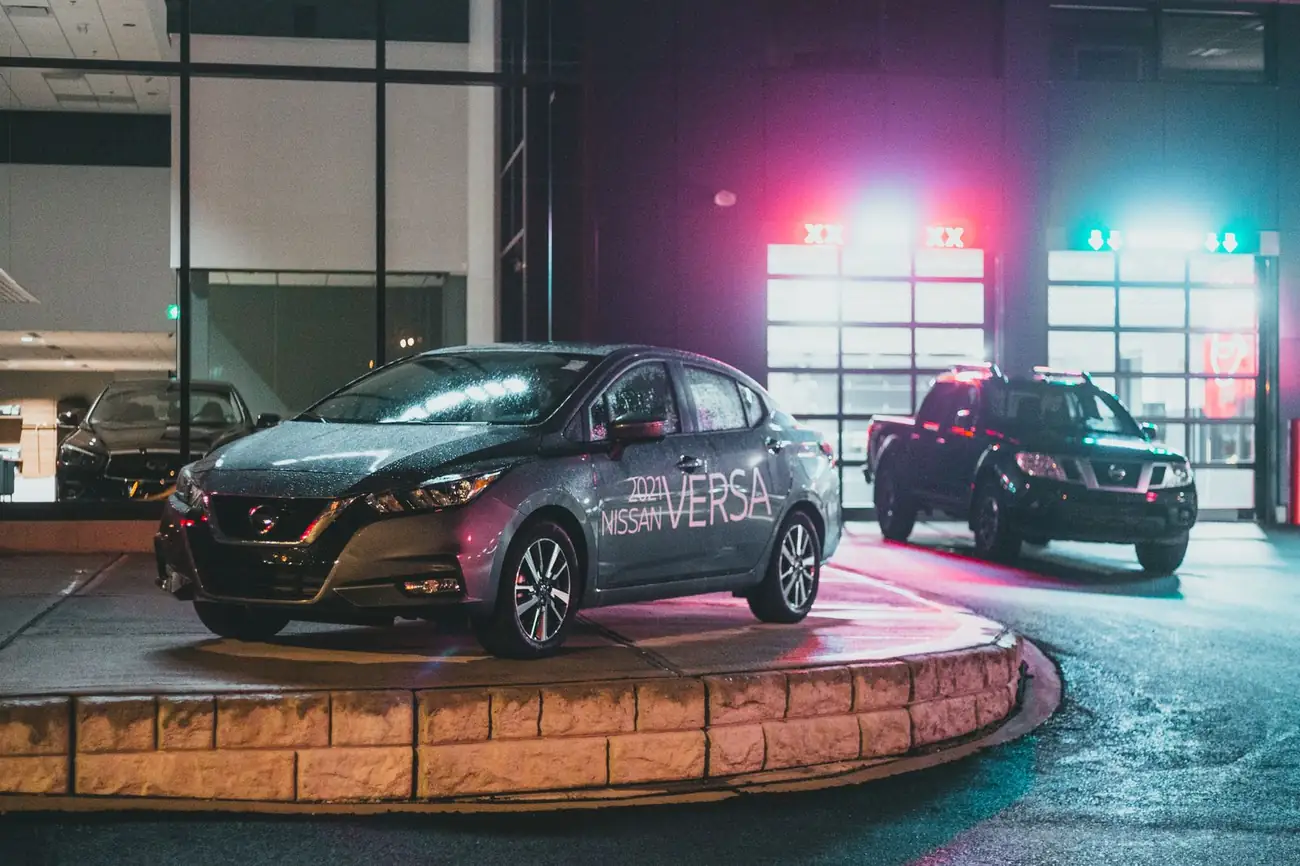 Cars in a showroom at night
