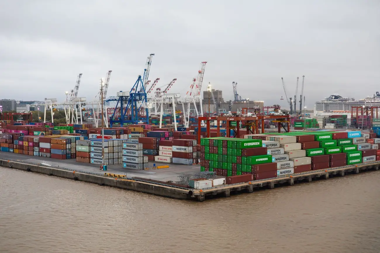 Container port with stacked cargo and cranes