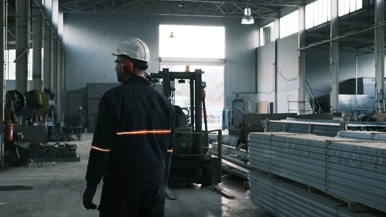Worker in protective gear in a modern factory