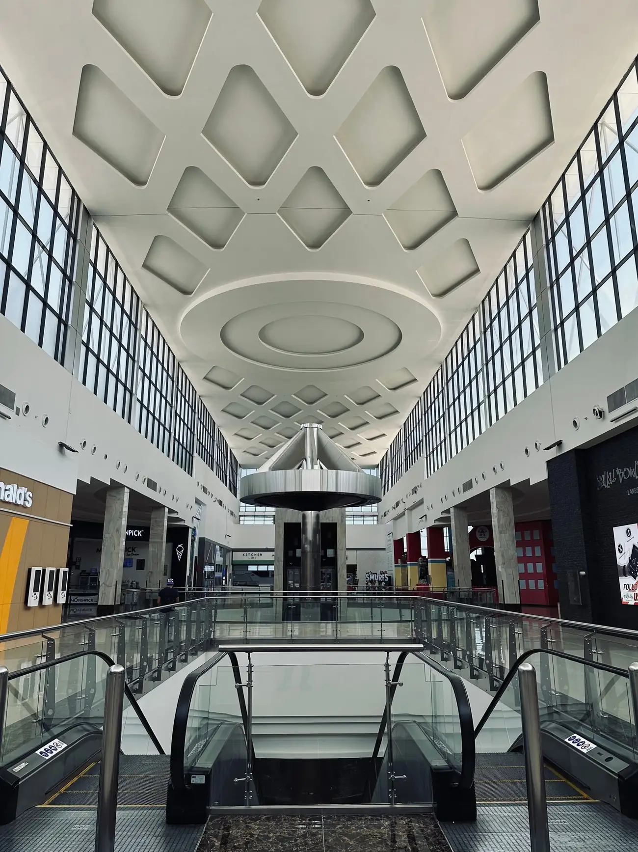 Modern shopping mall interior with geometric ceiling