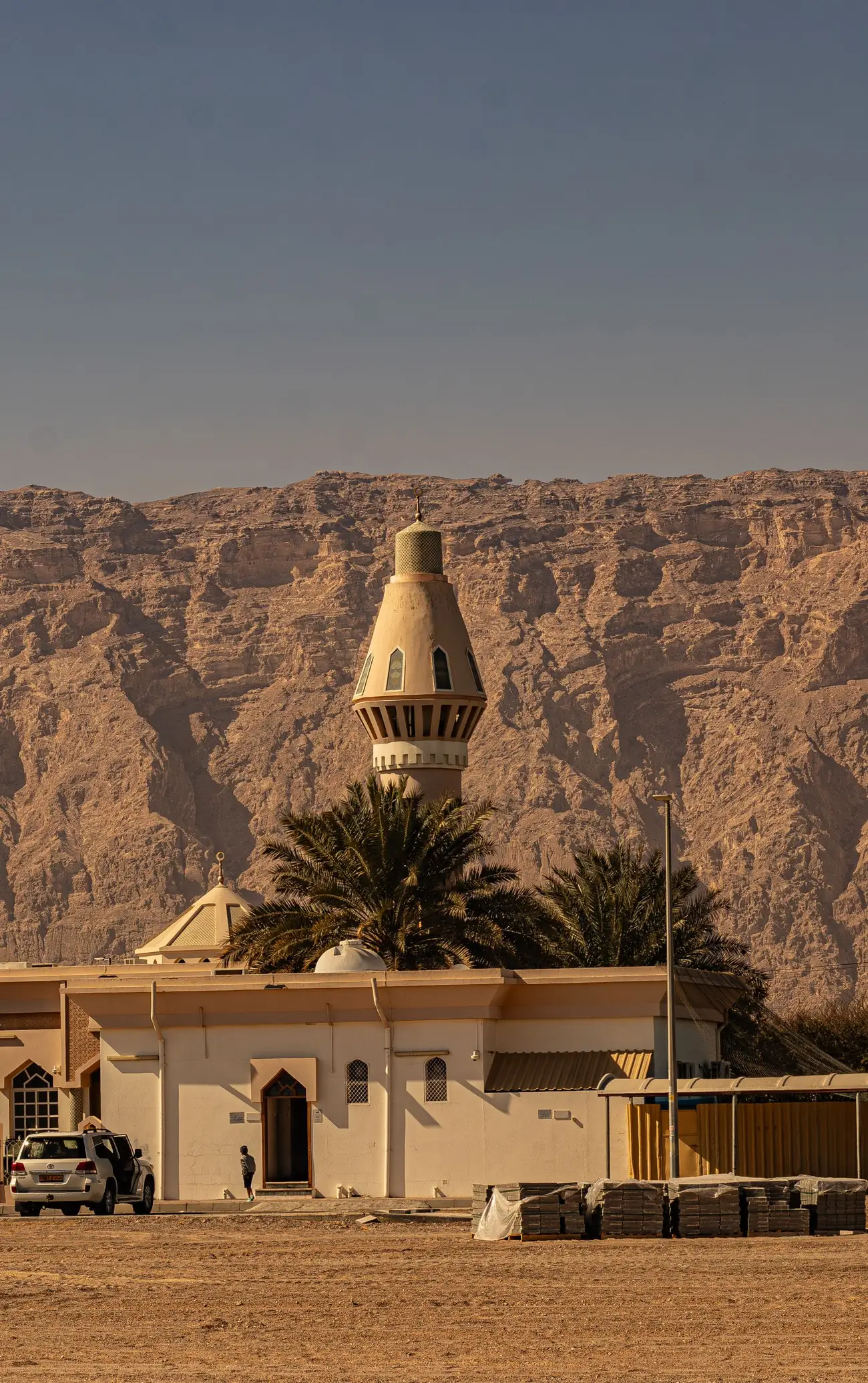 Mosque in Al Ain against Jebel Hafeet rock formations
