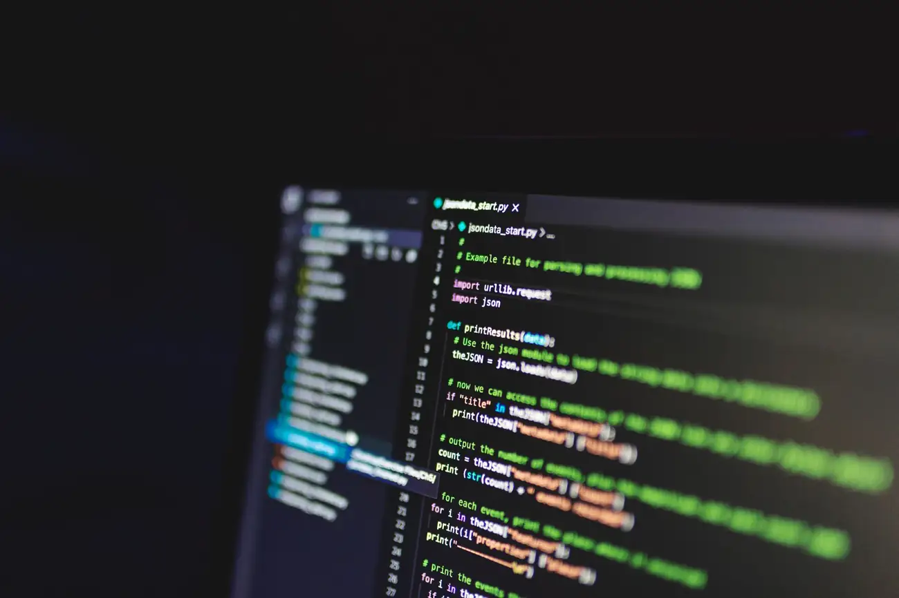 Lines of code on a screen in a dark room
