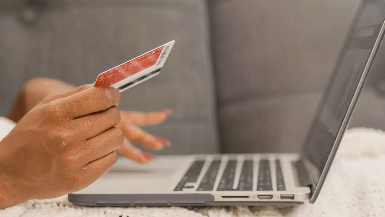 Customer paying online with a card at a laptop