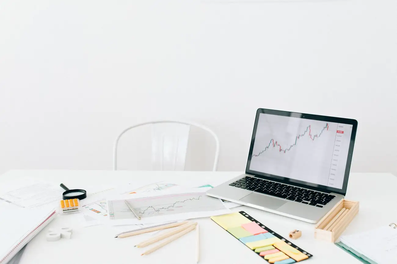Workspace with laptop, documents and notes